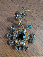 Front view showing floral starburst design and rhinestone colors