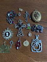 Group shot of all pendants and charms on wood surface