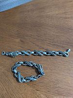 Full view of dragon chain bracelet displayed open and closed