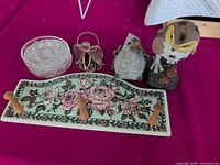 Group shot of all items: ceramic wall rack, stacked glass dishes, metal angel holder, resin bird figurines