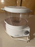 Full view of Black & Decker electric steamer showing base, bowl, lid, cord and timer dial
