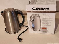 Kettle, power cord, and original box front view showing model