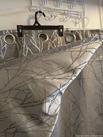 Close view of fabric front and reverse showing branch print and grommets