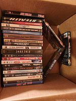 Box showing stacked DVD spines such as Unstoppable, Stealth, Starsky & Hutch