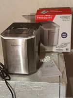 Frigidaire countertop ice maker, original box, manual visible