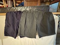 Group view of both pairs of shorts, navy and dark gray