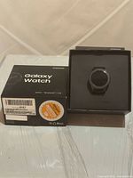 Samsung Galaxy Watch 42mm in box beside outer retail box