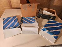 Overall lot with two opened reams of paper/card stock, envelopes in box, envelopes in black holder
