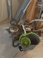 Two FilterQueen canister vacuums with hoses, wands and attachments