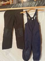 Full view of both garments hanging, showing style and color