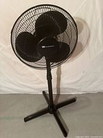 Front view of black White-Westinghouse pedestal fan showing blades, grille, base