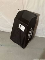 Front view of Yardworks grass catcher showing mesh body, frame, hooks and logo