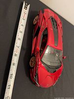 Top view of red Lamborghini model with measuring tape