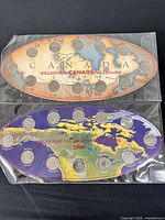 Front views of both 1999 and 2000 Millennium quarter sets in sleeves