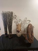 Full lot showing two twig bundles, deer head, and reindeer statue