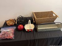 Overview of baskets, faux fruit and metal tray on table