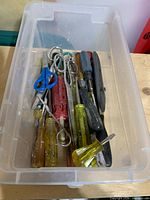 Top view of bin showing screwdrivers, scissors, utility knife, file