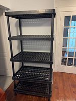 Front view of entire 5-tier plastic shelf