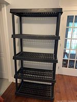 Front view of full 5-tier black plastic shelving unit