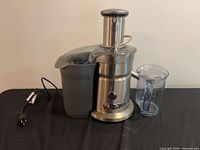 Full view of juicer with pulp container and pitcher