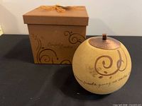 Candle holder with lid beside original box