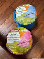 Both Coleman kids sleeping bags in stuff sacks, Catnap pink and Explorer blue