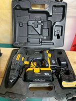 Open hard case showing Workforce 18V drill, battery, charger and case interior