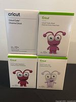 Front view of four Cricut Cutie boxes showing product images and age rating