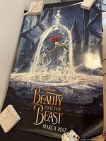 Full view of rolled poster held flat showing artwork and overall condition