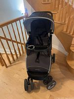 Front view of gray/charcoal Eddie Bauer stroller showing canopy, child tray and wheels