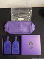 Full set showing pouch, two tags in box, outer gift box, and plastic bag