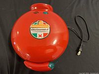 Closed red Elite Gourmet quesadilla maker with power cord