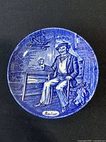 Front view of blue and white plate with sailor scene
