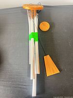 Full view of five-tube aluminum wind chime with wood top, clapper and wind catcher