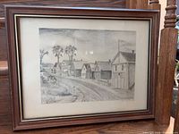 Full view of framed monochrome village scene artwork