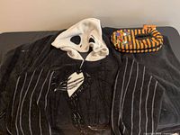 Blanket spread showing hood with Jack Skellington face and Garfield slipper socks on side