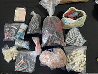 All bags and container of assorted curlers laid out