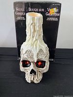 Front view of LED skull candle and box