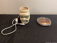 Ceramic wax warmer with plug cord and wax melts pack side by side