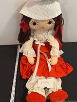 Front view of full doll with measuring tape and 1984 tag visible