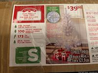 Close-up of product label showing specifications: 4 ft height, 100 LED lights, 173 tips, 28 in diameter