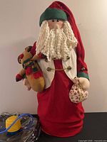Front view of inflatable plush Santa with accessories visible