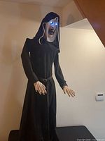 Front view of full animatronic showing stature, costume, hands