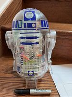 Front view of assembled clear R2-D2 droid with marker for scale