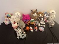 Full group of 20 plush animals on table