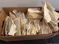 Top view of cardboard box filled with sewing pattern envelopes