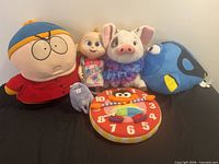 All six toys lined up on black surface