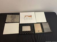 Front view of seven picture frames and silver wedding album