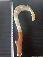 Full view of hook beside ruler showing length