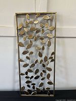 Full view of metal leaf wall art showing design and finish